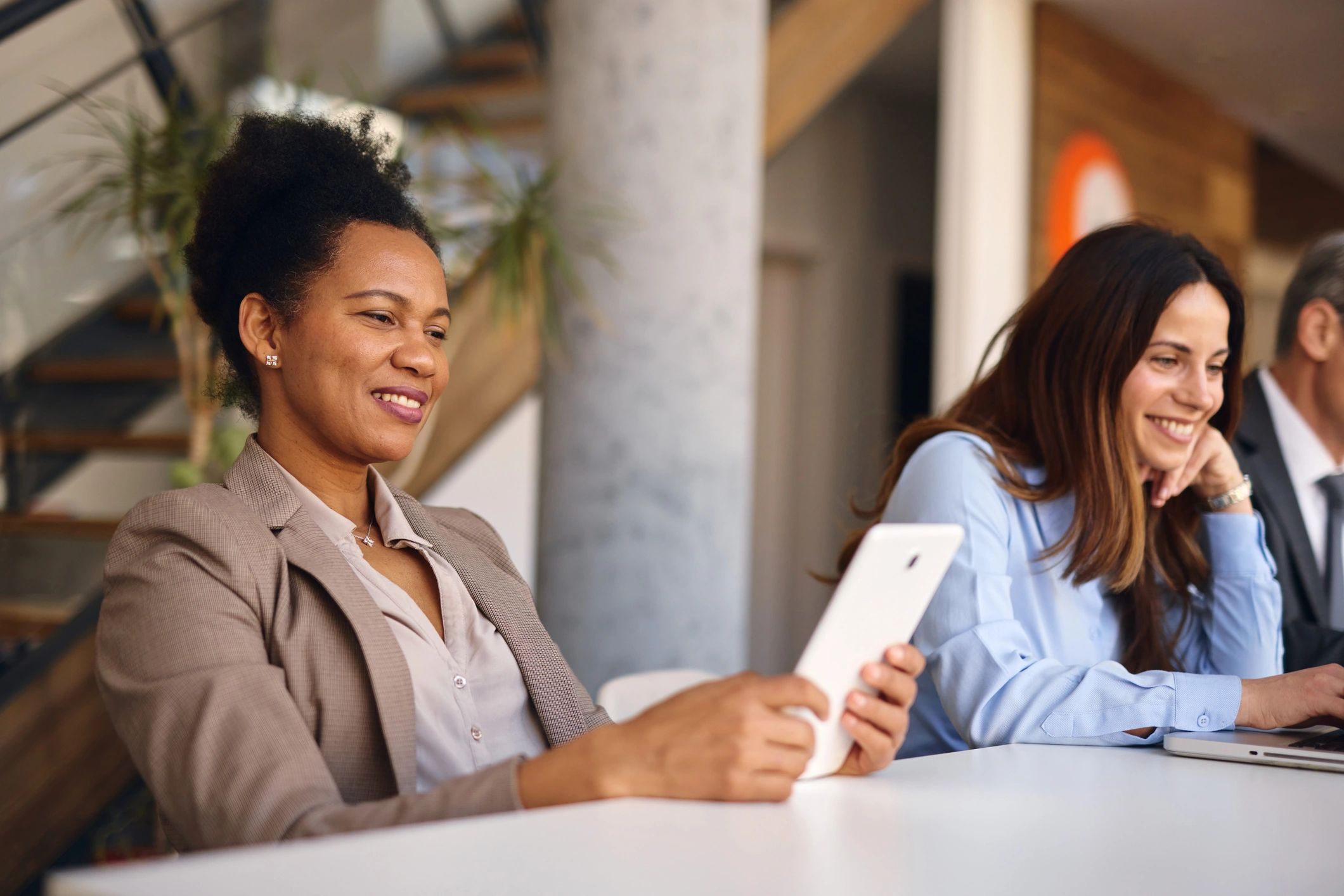 Business professional using a tablet to represent modern app experiences