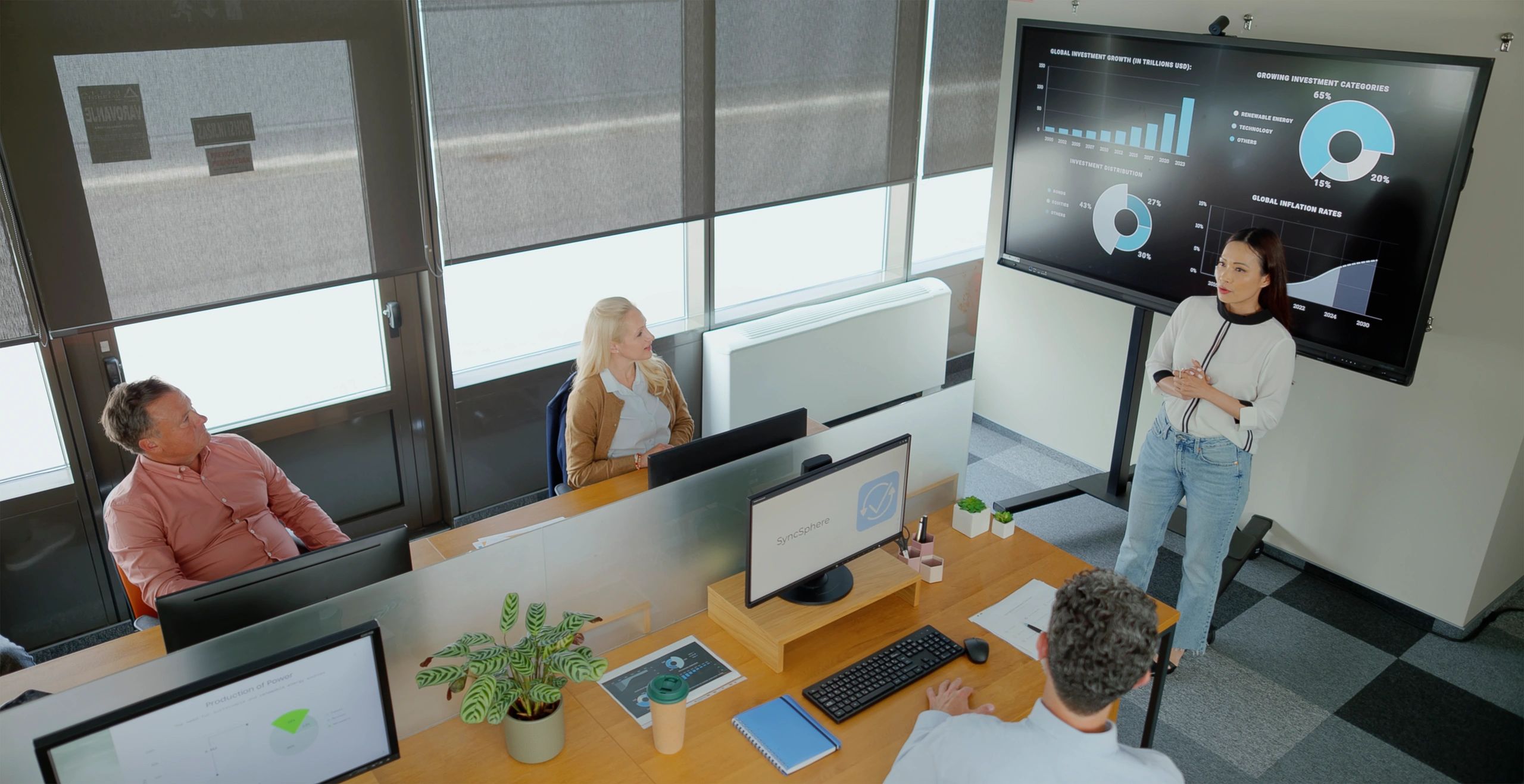 Business team analyzing digital charts in a corporate meeting room